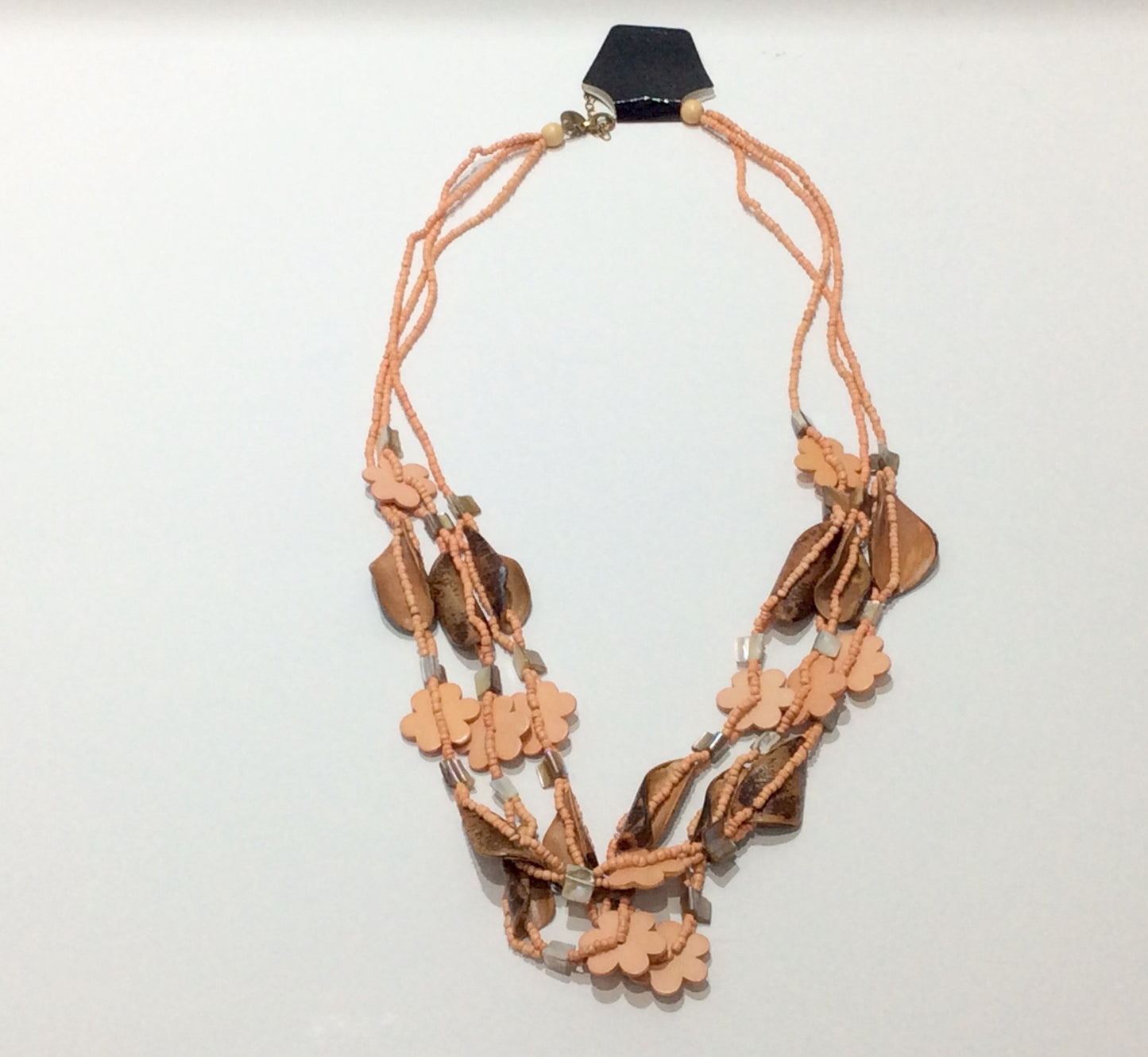 Necklace-Three strand beaded necklace with wooden flower shaped, shell and leather beads